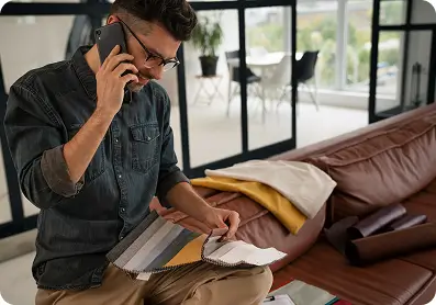 Man picking from materials while talking on the phone
